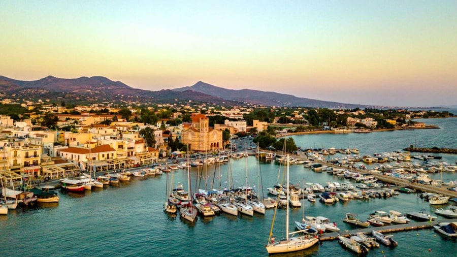 Yachts and fishing boats moored in Aegina town harbour at dusk, a starting point for an Aegina boat trip