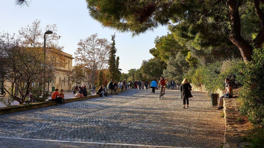 An Athens bike tour rides the car-free Dionysiou Areopagitou walkway below the Acropolis