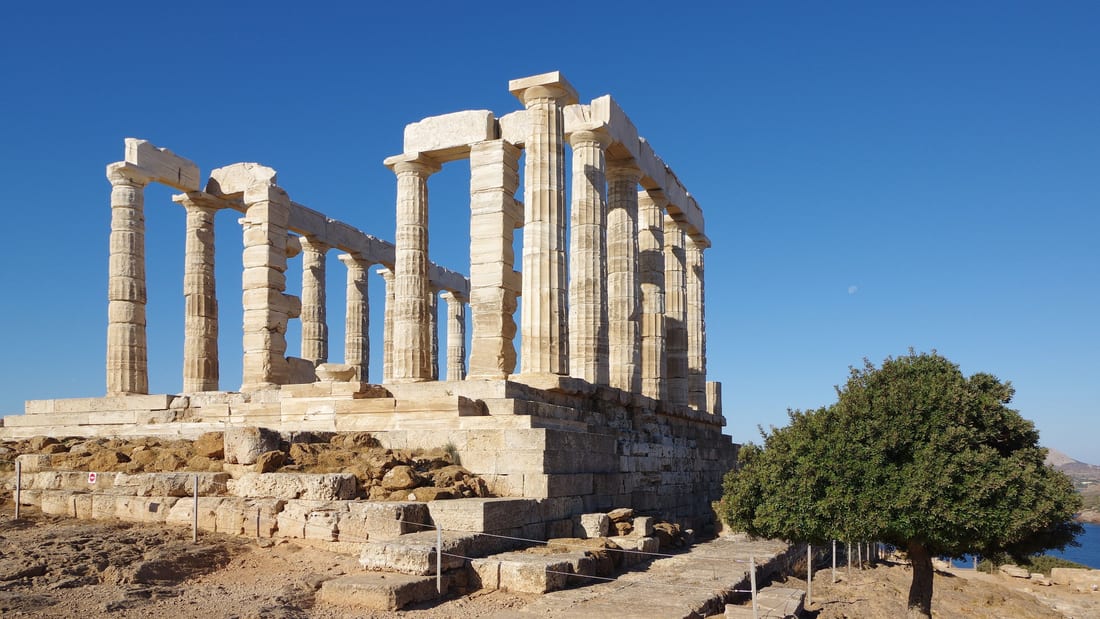 An Athens day trip reaches the Temple of Poseidon on Cape Sounion, its marble columns above the Aegean