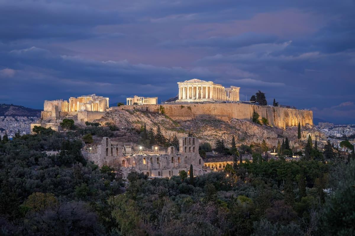 An Athens night tour sees the Acropolis lit at dusk, the Parthenon glowing above the Odeon of Herodes Atticus