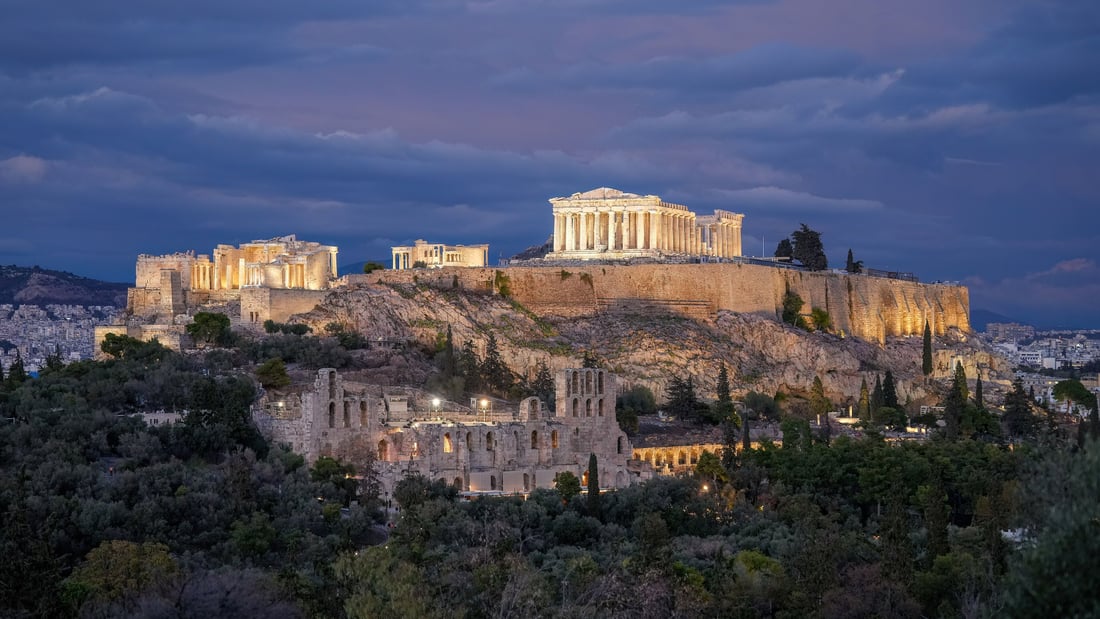 An Athens night tour sees the Acropolis lit at dusk, the Parthenon glowing above the Odeon of Herodes Atticus