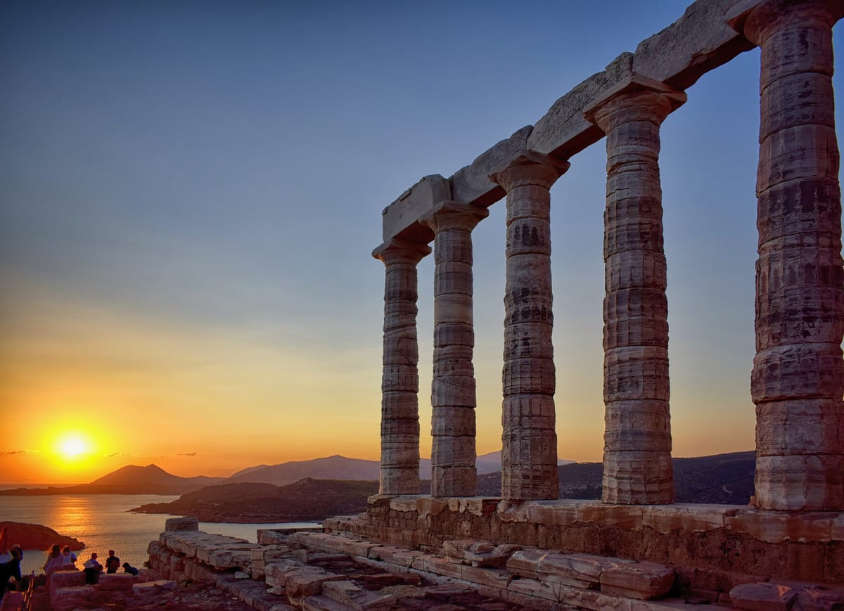 A Cape Sounion tour watches the sunset beside the Temple of Poseidon