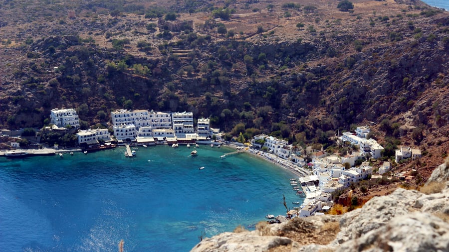 A Chania boat trip reaches the white houses of Loutro around its turquoise bay on the south coast