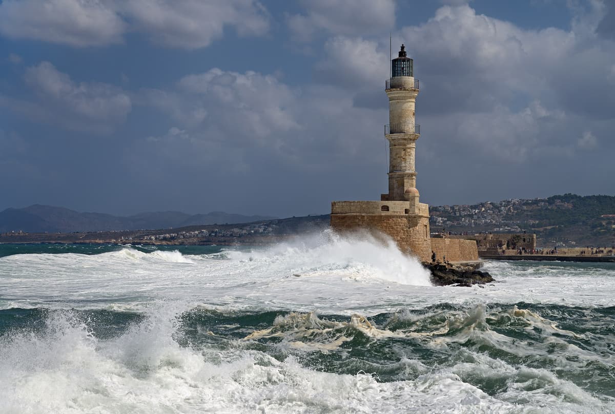 A Chania food tour passes the Venetian lighthouse of Chania in Crete