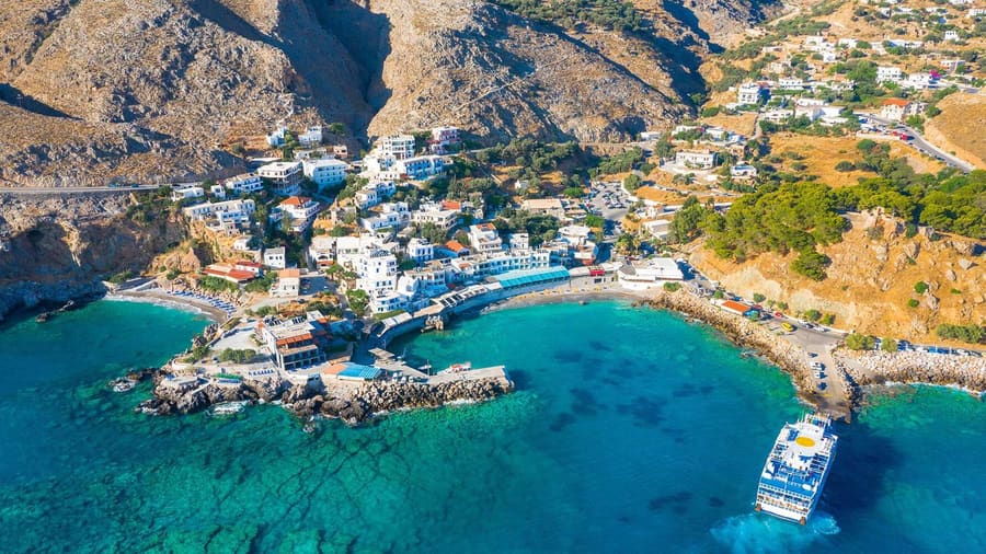Chora Sfakion harbour and village above turquoise water, an end point of a Chania hiking tour on the south coast