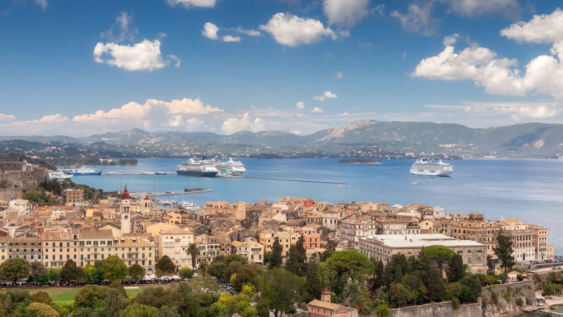 A Corfu Old Town walking tour looks over the rooftops and bell towers of the old town above the harbour