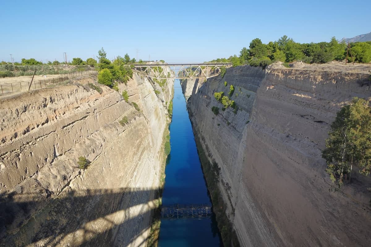A Corinth Canal tour looks down the straight channel cut between high rock walls