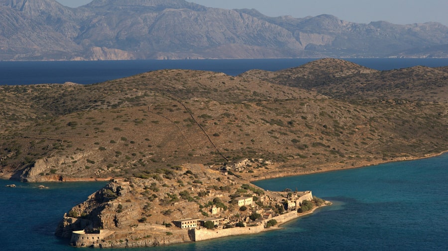A Crete boat trip reaches Spinalonga, the walled islet at the mouth of the bay of Elounda