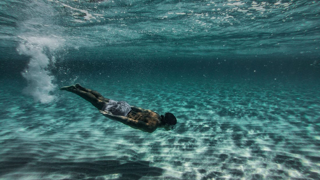 Crete scuba diving starts in clear shallow water over a sandy sea floor off the coast of Crete