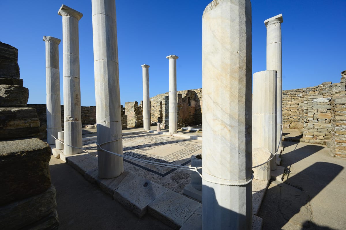 A Delos tour walks among the columns of the House of Dionysus