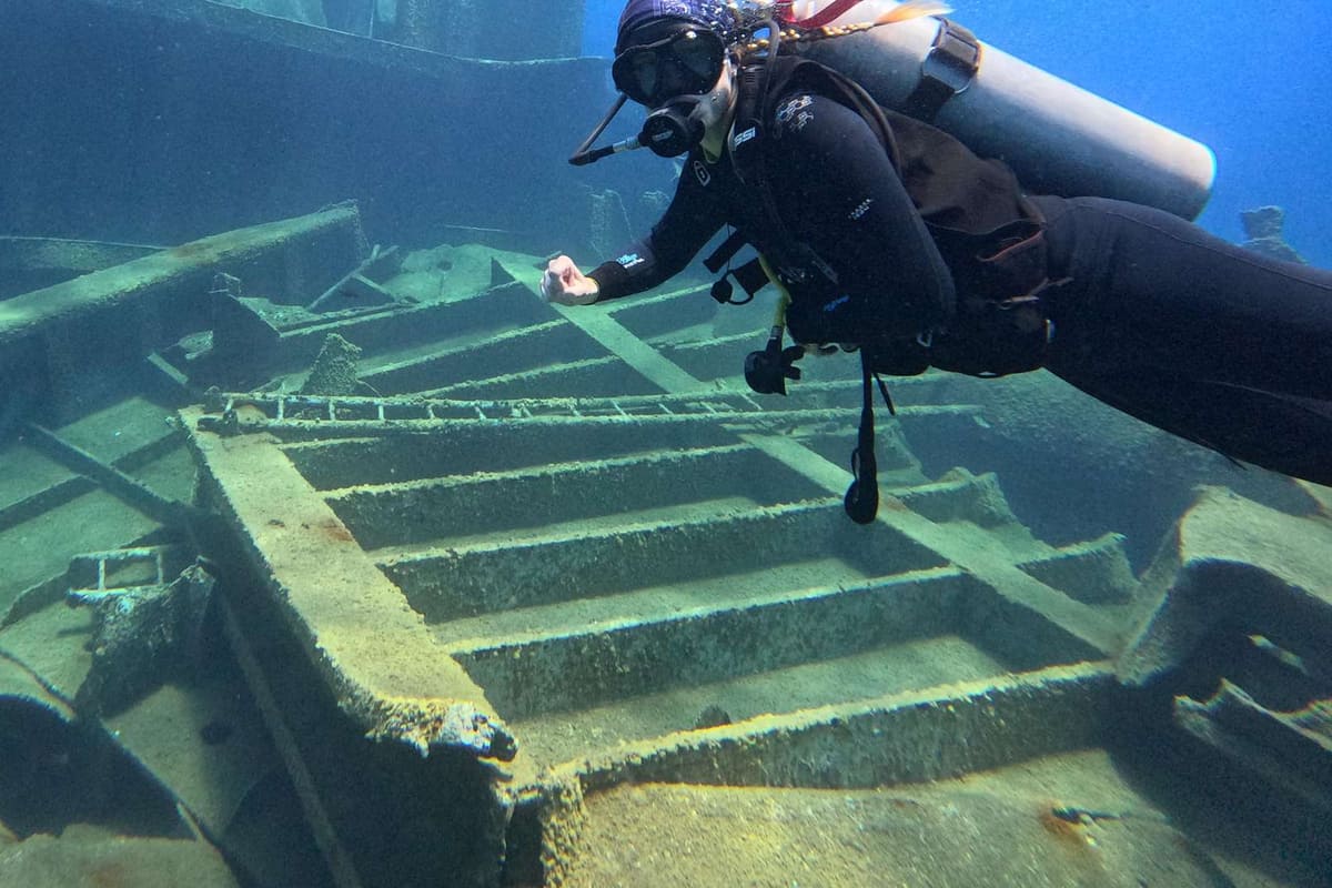 A diver swims over a shipwreck on a Heraklion scuba diving trip off northern Crete