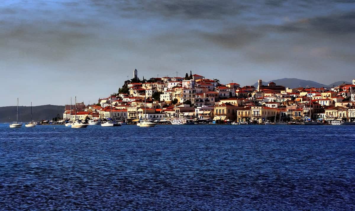 A Hydra Poros Aegina cruise passes the town of Poros on its hill