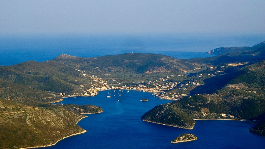 An Ithaca day trip looks down on the Bay of Vathy, the capital of the island, from the hills above