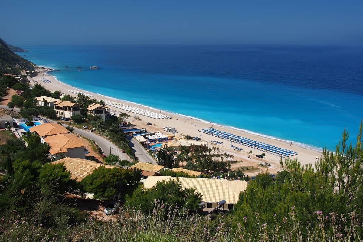 A Lefkada island tour looks down on Kathisma, a long white beach on the turquoise west coast of the island
