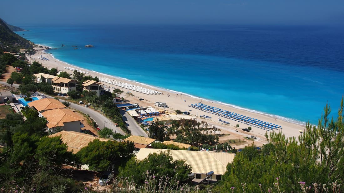 A Lefkada island tour looks down on Kathisma, a long white beach on the turquoise west coast of the island