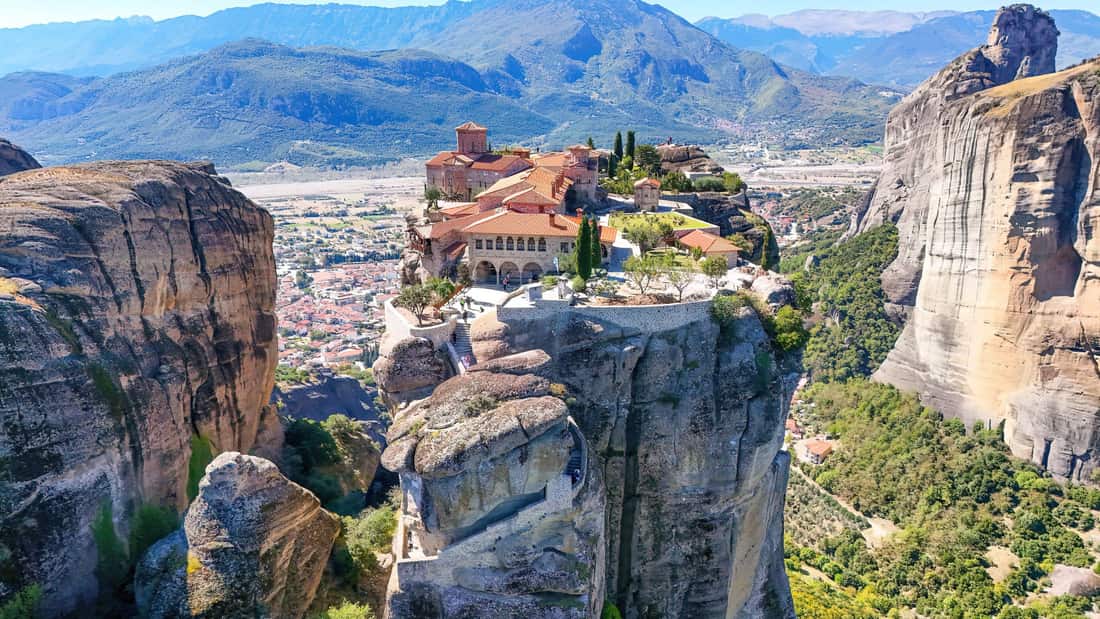 A Meteora hiking tour looks across to the Holy Trinity monastery on its rock pillar above Kalambaka