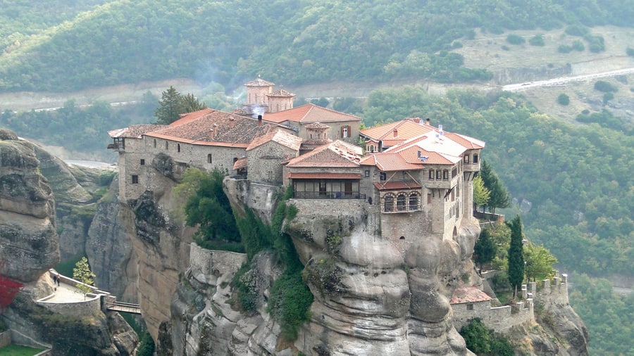 A Meteora sunset tour passes the Varlaam monastery built on the summit of its sandstone pillar