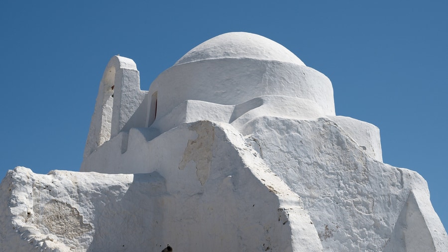 A Mykonos island tour visits Panagia Paraportiani, the whitewashed church formed of joined chapels