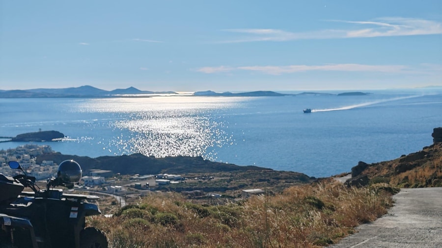 A quad parked on a Naxos ATV tour road high above the coast, with the sea and nearby islands behind