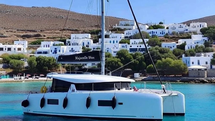Sailing catamaran moored off the white houses of Koufonisia on a Naxos catamaran cruise