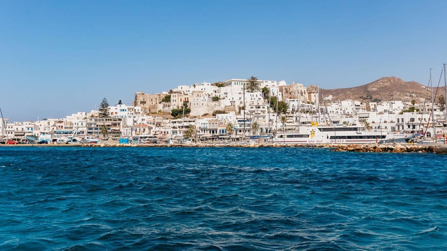 Naxos town and its hilltop castle seen from the water at the start of a Naxos sailing tour