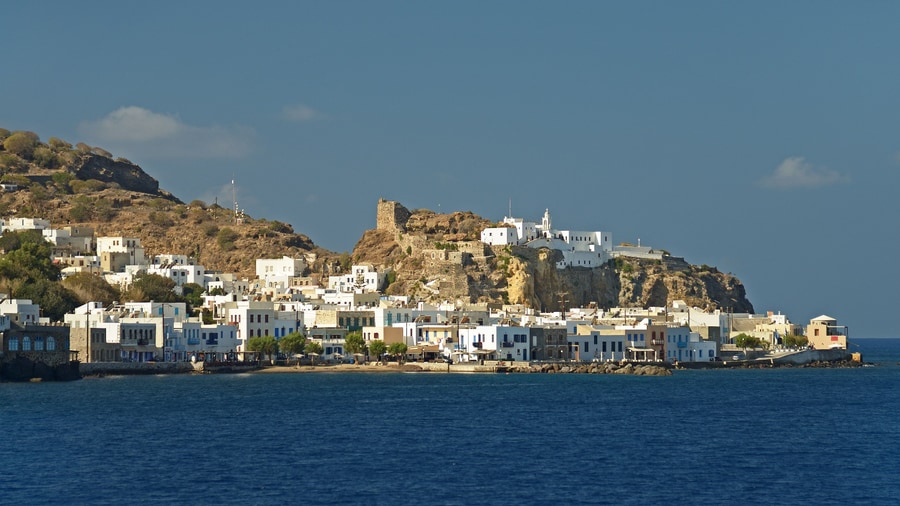 A Nisyros volcano tour lands at Mandraki, its white houses below the castle and monastery on the rock