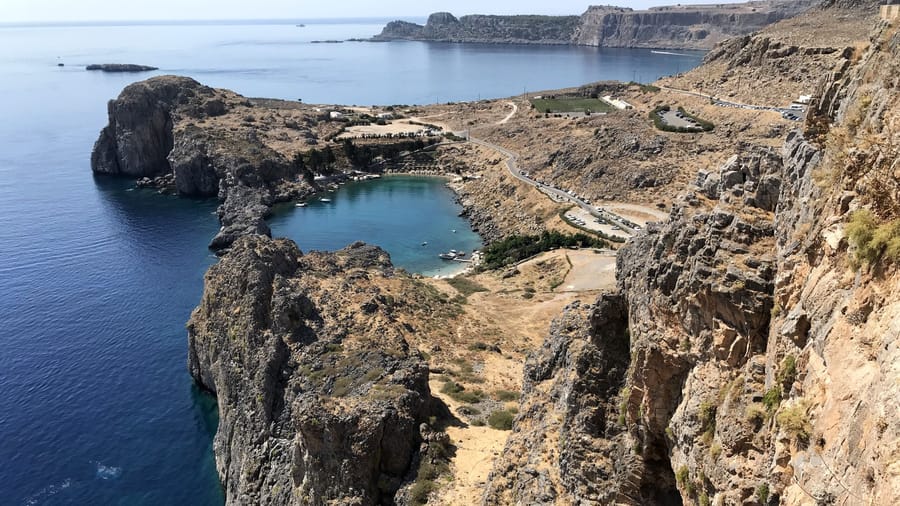 A Rhodes snorkeling tour near Lindos reaches Saint Paul Bay, an almost closed cove of clear water below the cliffs