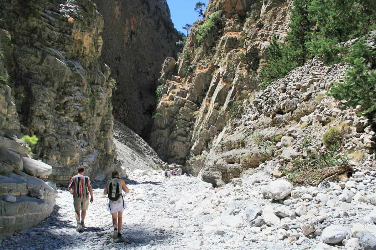 A Samaria Gorge tour on the stony path between the high cliffs of the gorge