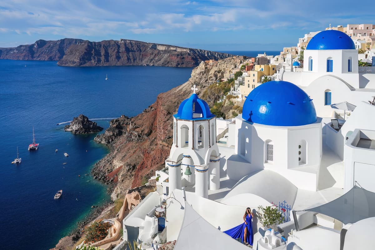 A Santorini photo tour frames the three blue domes of Oia above the caldera, the most photographed view on the island