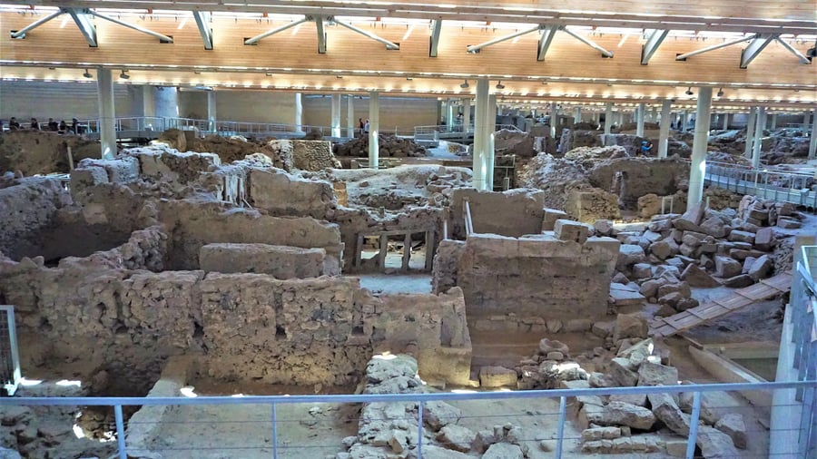 A Santorini shore excursion visits Akrotiri, the Bronze Age town preserved under volcanic ash and a modern roof