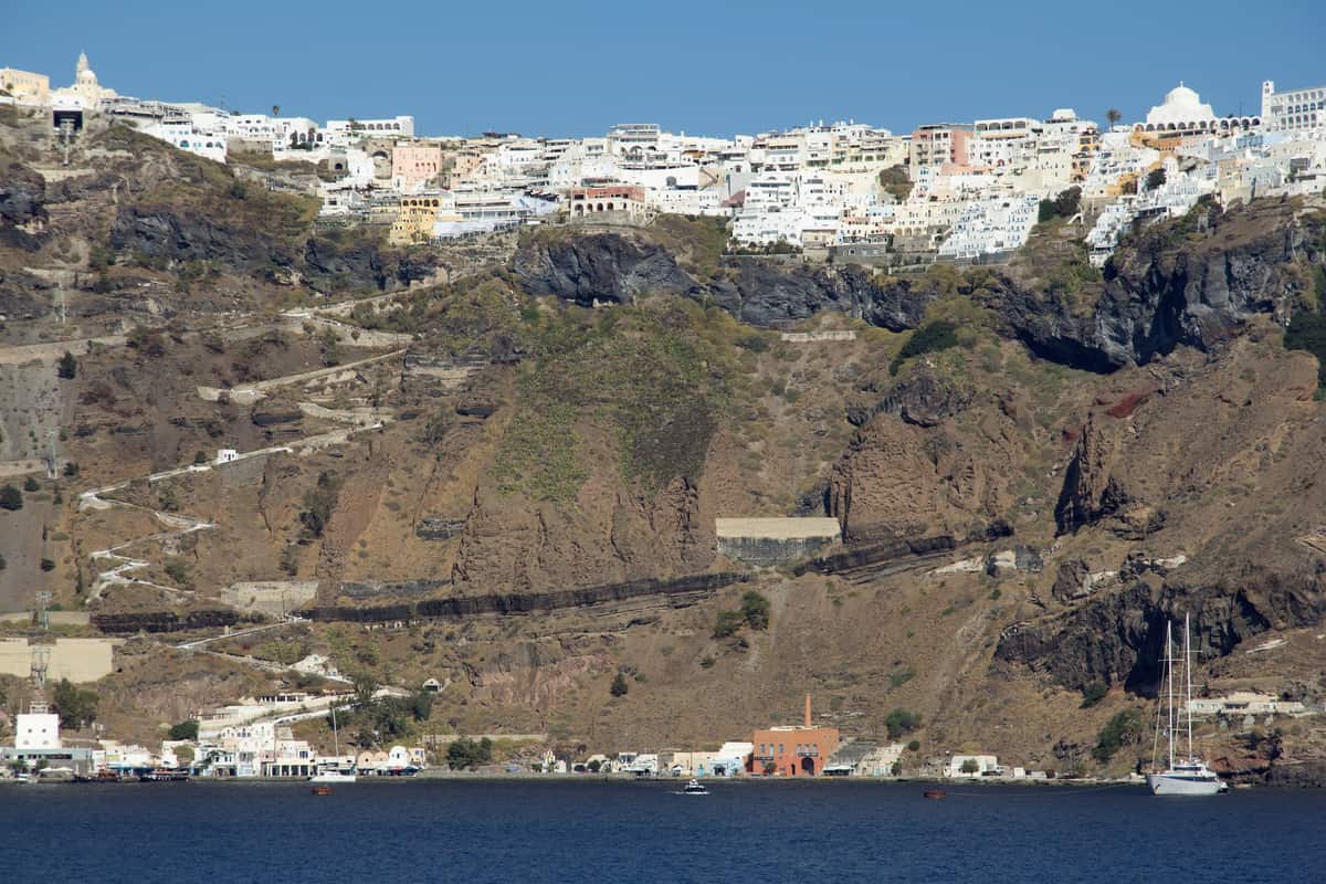 A Santorini shore excursion starts at the old port below Fira, whose white houses line the top of the caldera cliff