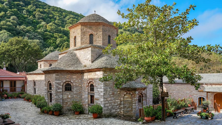 A Skiathos island tour visits the Evangelistria Monastery, its stone church set in the green hills