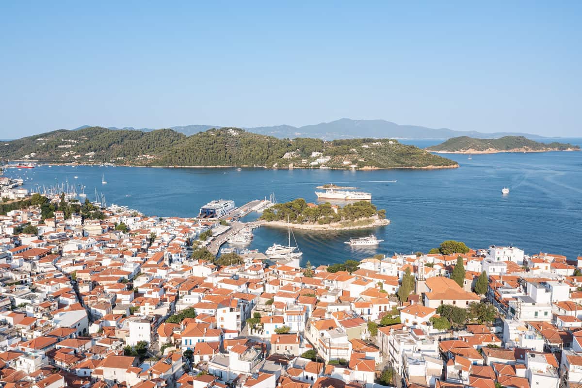 A Skiathos island tour starts in Skiathos Town, its red roofs spread around the harbour and the pine-covered Bourtzi