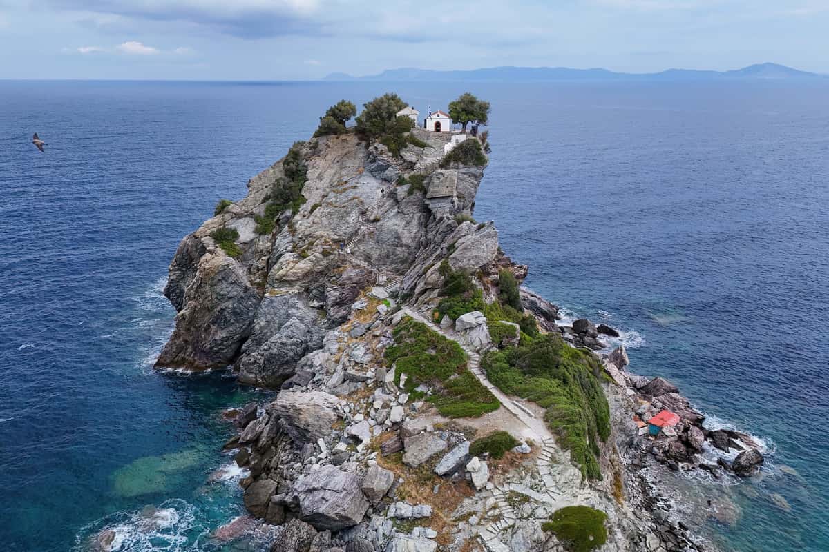 A Skopelos boat trip passes the chapel of Agios Ioannis on top of its rock above the sea