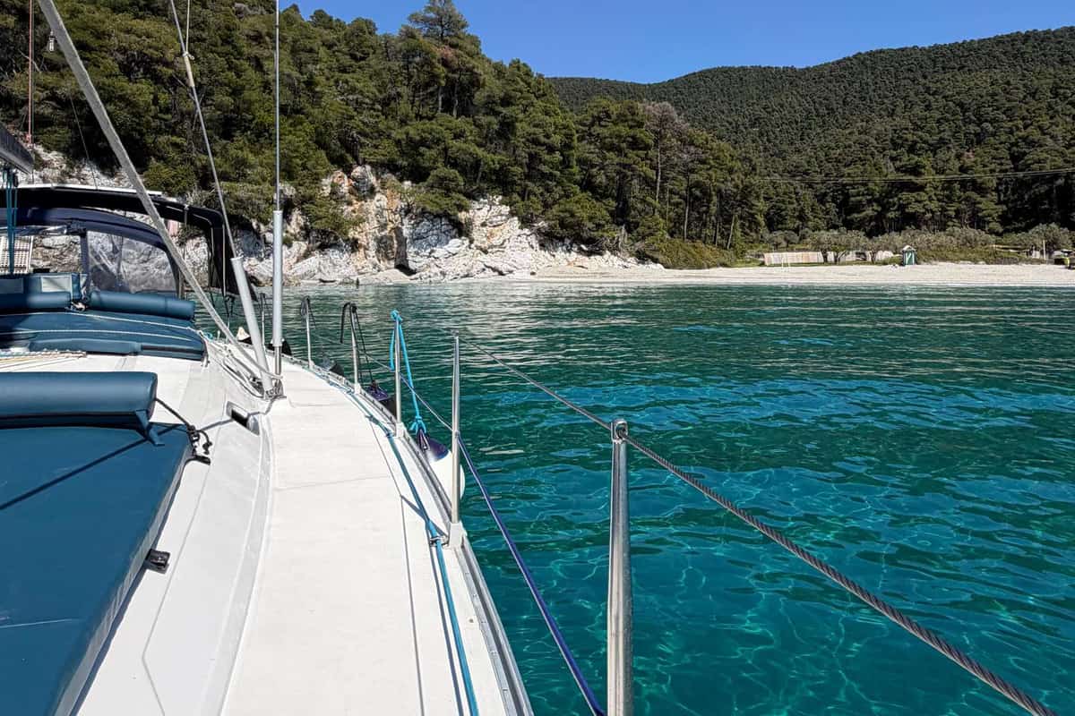 Skopelos sailing tour yacht at anchor in turquoise water off a pine-covered beach