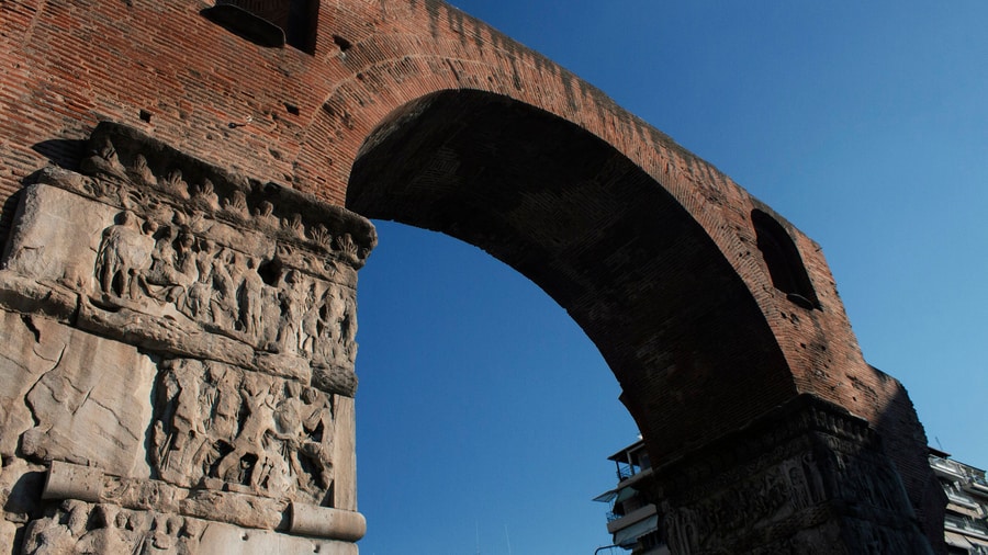 A Thessaloniki walking tour passes under the Arch of Galerius, its brick arch rising over carved marble piers