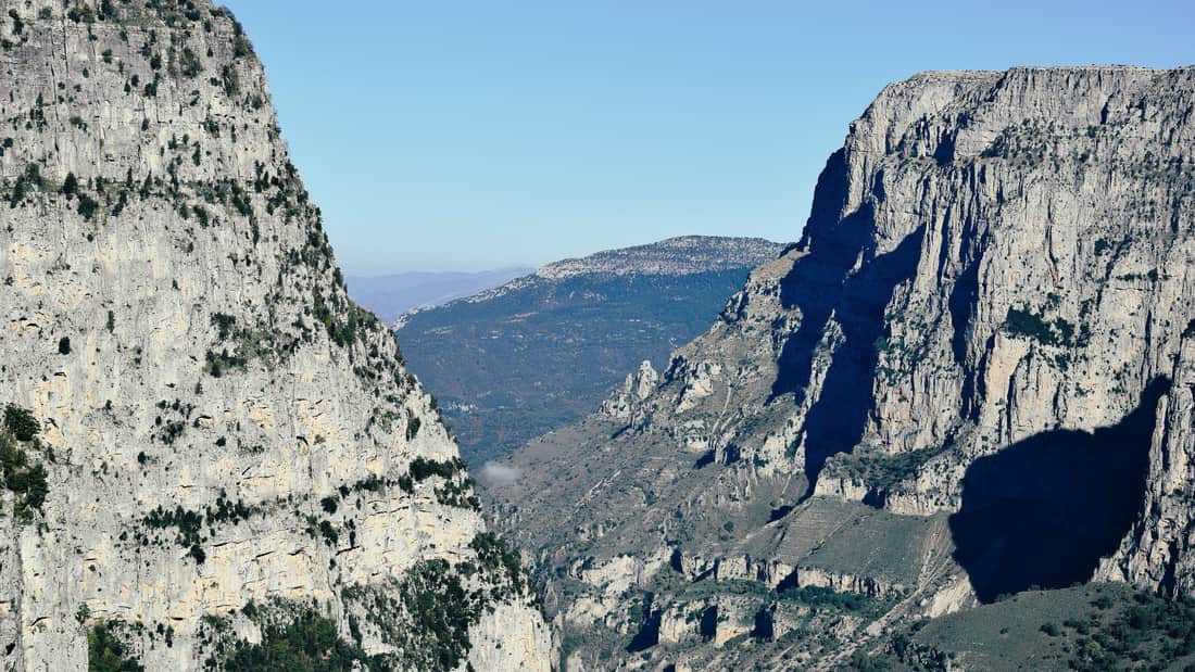 A Vikos gorge hike looks down into the sheer limestone walls of the canyon from the Beloi viewpoint