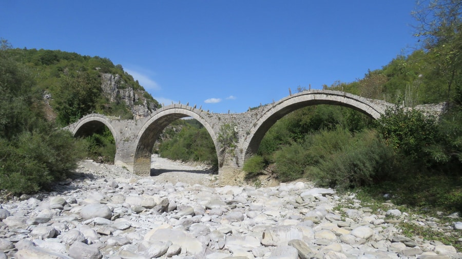 A Vikos gorge hike passes the three-arched Kalogeriko stone bridge of Zagori